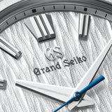 Close-up of a Grand Seiko watch face with detailed design and branding.