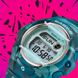 Close-up of the dial on the Casio BABY-G BG169CM-2D Digital Women's Watch, showing the translucent teal colour dial and digital display detail. The camouflage bezel pattern is shown up close.