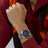 TAG Heuer Formula 1 Chronograph CAZ1014.BA0842 shown worn on the wrist, illustrating the case proportions and steel bracelet fit. The blue dial stands out against the sleeve in frame.