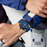 TAG Heuer Formula 1 Chronograph CAZ101AV.FT8077 shown worn on the wrist, illustrating the case proportions and blue rubber strap fit. The blue dial stands out against the white sleeve in frame.