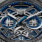 TAG Heuer Carrera Chronograph Extreme Sport CBU2081.BF0007 captured in extreme close-up on the openworked dial, revealing the movement components framed by the blue flange. The rhodium-plated hands and indexes with Super-LumiNova sit against the skeletonized dial.