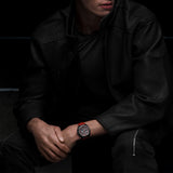 TAG Heuer Formula 1 Chronograph CBZ2085.FT8093 shown worn on the wrist, illustrating the case proportions and red rubber strap fit. The black dial stands out against the sleeve in frame.