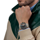 TAG Heuer Formula 1 Chronograph x Gulf CBZ208B.BF0009 shown worn on the wrist, illustrating the case proportions and titanium bracelet fit. The Gulf blue and orange dial stands out against the sleeve in frame.