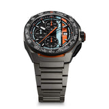 TAG Heuer Formula 1 Chronograph x Gulf CBZ208B.BF0009 photographed at an angle highlighting the black dial's chronograph subdials and forged carbon bezel. The titanium bracelet curves away from the lugs, showing its link construction.