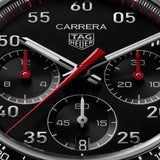 TAG Heuer Carrera Chronograph Sport CDB2110.BA0054 captured in extreme close-up on the black opalin dial, highlighting the red-lacquered chronograph hands and silver numerals. The Super-LumiNova-filled markers sit against the black dial surface.