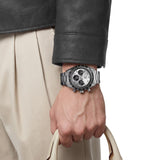TAG Heuer Carrera Chronograph Sport CDB2113.BA0054 shown worn on the wrist, illustrating the case proportions and steel bracelet fit. The silver dial stands out against the sleeve in frame.