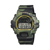 Casio G-Shock DW6900CMG-3D front view — classic 6900 digital case with green camouflage MAP-printed bezel, gold vapour deposition dial and hands, and Super Illuminator LED backlight.