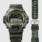 Casio G-Shock DW6900CMG-3D dial close-up showing the gold-coloured vapour deposition finish across the dial face and hands against the classic 6900 triple LCD display layout.