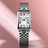 Frederique Constant Women's 28mm Stainless Steel Quartz Watch FC-200MPW2AC6B styled in a lifestyle setting, reflecting its elegant, Art Deco-inspired design suited to dressier occasions. The mother-of-pearl dial and polished stainless steel case complement a refined, feminine look.