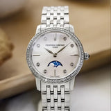 Frederique Constant 30mm Quartz Moonphase Watch FC-206MPWD1S6B styled in a lifestyle setting, reflecting its elegant, jewellery-inspired design suited to dressier occasions. The mother-of-pearl dial and diamond indexes complement a refined, feminine look.