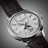 Frederique Constant 37mm Quartz Moonphase Watch FC-206S3S6 styled in a lifestyle setting, reflecting its refined, versatile design suited to both business and evening occasions. The silver-tone dial and leather strap complement a sophisticated, understated look.