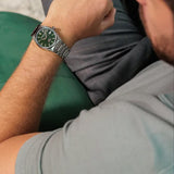 Frederique Constant Highlife Automatic COSC Watch FC-303GRS3NH6B worn on the wrist, demonstrating the comfortable fit of its 39mm case. The watch can be worn on its stainless steel bracelet or swapped to the included green nubuck leather strap.
