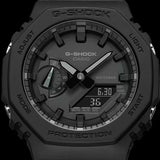 Casio G-Shock GA-2100-1A1 watch front view, featuring a 45.4mm all-black octagonal resin case with Carbon Core Guard construction, clean monochromatic analogue-digital dial with Arabic numeral indices, inverted LCD display, and distinctive integrated band design.