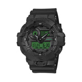 Casio G-Shock GA100BEG-1A front view, featuring the large 55mm all-black round resin case with electro green LCD accents, three-dial analogue-digital layout with aluminium hands, four symmetrical LCD windows, oversized checkered anti-slip buttons, and bold G-Shock branding in a striking black and electro green colourway.