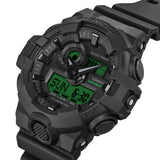 Casio G-Shock GA100BEG-1A front view — all-black round resin case with electro green LCD accents, analogue-digital three-dial layout. 55mm x 51.2mm x 16.9mm, 70 grams, shock resistant, magnetic resistant, 200M water resistant.