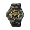 The Casio G-Shock Analogue Digital Watch GA700CMG-3A features a 57.5mm round resin case with four-colour green camouflage MAP-printed bezel, gold vapour deposition dial and sculpted hands, front LED button at 6 o'clock, and matching camouflage resin band.