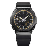From this angle, the Casio G-Shock Analogue Digital Men's Watch GM2100LXB-1A9 reveals the black ion-plated steel bezel's polished facets and the layered gold detailing across the dial, frame, and logo against the all-black case.