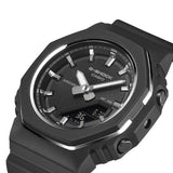 Three-quarter angle view of the Casio G-SHOCK Analogue Digital Women's Watch GMA-P2110B-1A, 40.5mm case, highlighting the octagonal bezel shape and slim metal ring detailing. The all-black resin case and band are visible from this angle.