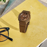 Lifestyle shot of the Casio G-SHOCK Analogue Digital Women's Watch GMA-P2110B-5A, 40.5mm case, styled in an everyday active setting. The compact all-brown design is shown in a natural, real-world context.