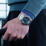 The Casio G-SHOCK 2500 Series Quartz Men’s Watch GMC2500D-1A2, 46.7mm case, worn on the wrist. The stainless steel bracelet and blue dial show the scale and fit.