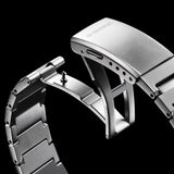 Close-up of a silver watch strap with 'G-Shock' branding on a black background