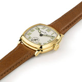 Hamilton American Classic Cushion Mechanical Women’s 30mm Watch H36119520 is captured at a 3/4 angle, showing the beige dial, yellow gold PVD case and brown leather strap together. The angle highlights the soft cushion shape of the case.