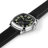Hamilton American Classic Cushion Mechanical Unisex 34mm Watch H36129730 is captured at a 3/4 angle, showing the black dial, steel case and black leather strap together. The angle highlights the soft cushion shape of the case.