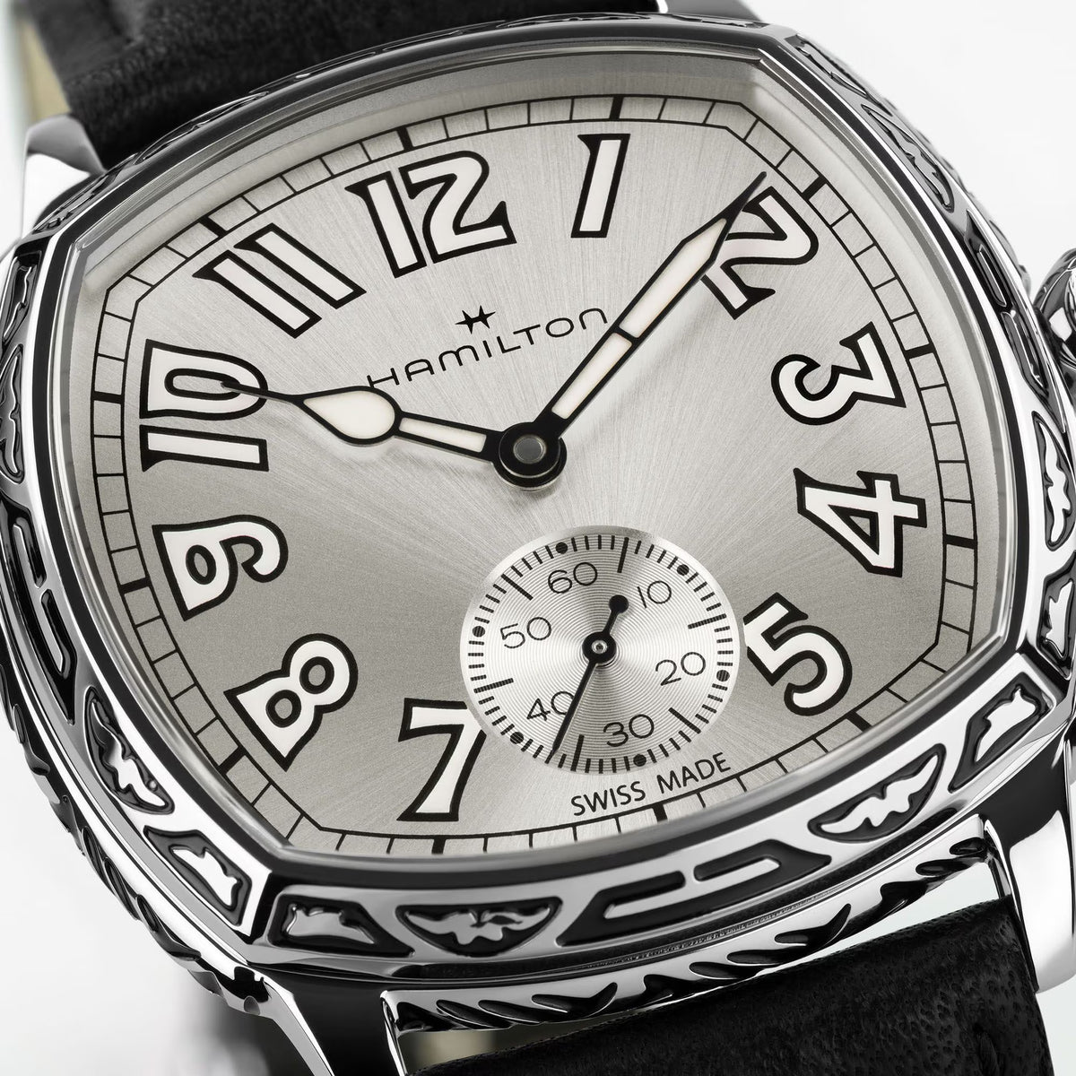 Hamilton American Classic Cushion Mechanical Unisex 34mm Watch H36149710 is shown in close up, revealing the square-style numerals, railway minute track and small seconds sub-dial. The slim hands stand out against the white dial.