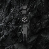 Hamilton Khaki Field Mechanical 38mm Watch H69409930 is shown at a 3/4 angle, highlighting the sapphire crystal, black dial, and NATO strap together. The angle showcases the watch's faithful recreation of its 1960s military field watch origins.
