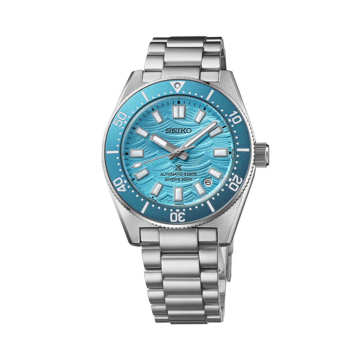 The Seiko Prospex Automatic Men’s 40mm Watch HBC011J features a blue dial with an embossed wave pattern, LumiBrite hands and markers, and a date window. The 40mm stainless steel case is fitted with a curved sapphire crystal and a blue rotating bezel.