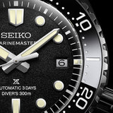 Close-up of a Seiko Seamaster Diver's 300m automatic watch with a black textured dial, silver-tone hands and markers, and a black rotating bezel with white numerals.