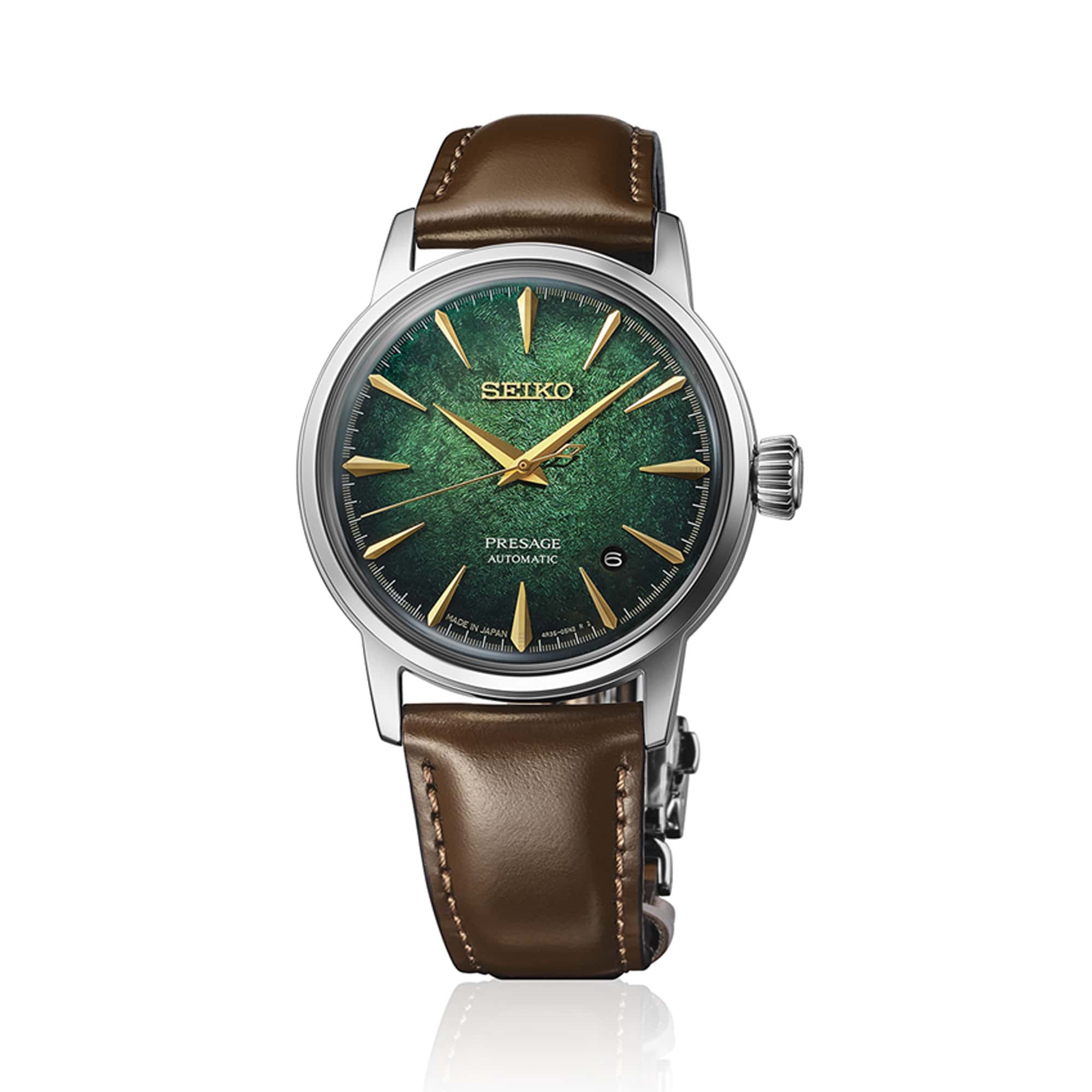 The Seiko Presage Cocktail Time HCB002J features a green textured gradient dial with yellow gold-toned accents, alongside a date window at the 4:30 position. The 38.5mm stainless steel case is fitted with box-shaped Hardlex crystal.