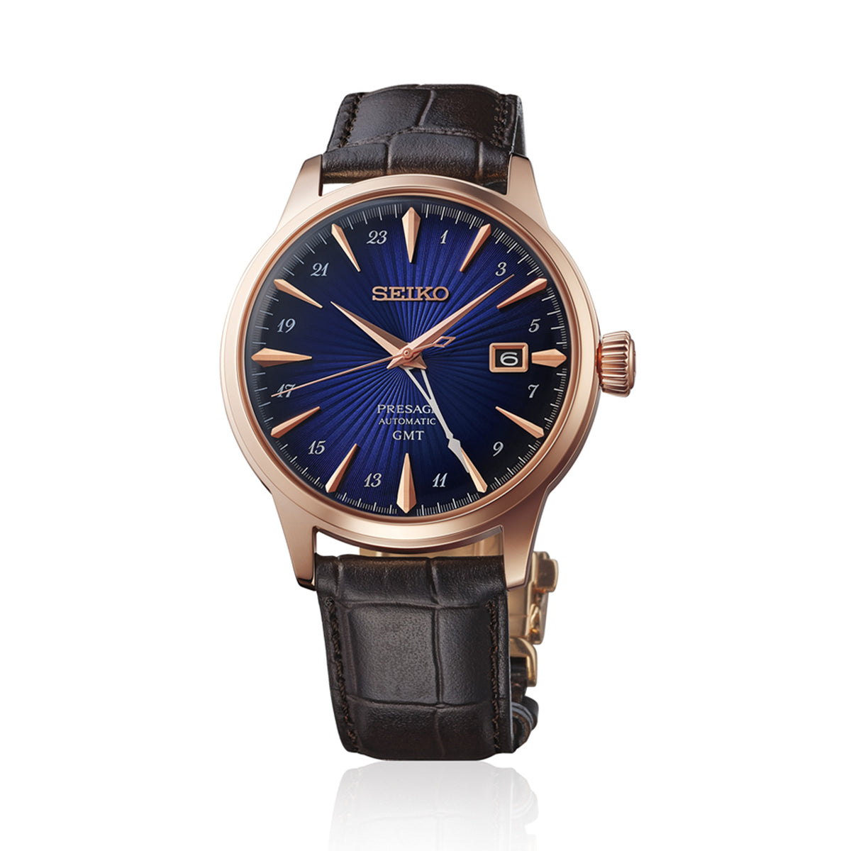 The Seiko Presage Automatic GMT Men’s 40.50mm Watch HCB004J features a champagne radial-patterned dial with gold-tone markers, a gold GMT hand and a date window at 3 o’clock. The 40.5mm gold-tone stainless steel case is fitted with a box-shaped Hardlex crystal.