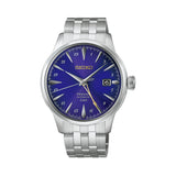 The Seiko Presage Cocktail Time Automatic GMT Men's 40.50mm Watch HCB006J features a purple radial-patterned dial with a gold logo, gold GMT hand and a date display. The 40.5mm stainless steel case is fitted with domed Hardlex crystal.