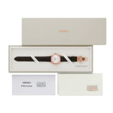 Seiko Presage watch with a dark brown leather strap and rose gold case, displayed in its original presentation box with the lid, warranty card, and certificate.