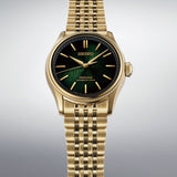 The Seiko Presage Automatic 38mm Watch HCC009J reveals the dial's fine textured pattern, gold-toned indexes and printed outer minute track in close detail.