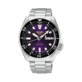 The Seiko 5 Sports SKX Series Automatic Men's 42.50mm Watch HDB003K features an Edo purple dial with a gold Seiko 5 Sports logo, LumiBrite hands and indexes, and a day/date display. The 42.5mm stainless steel case is fitted with a domed Hardlex crystal.