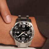 Close-up of the black dial on the Longines HydroConquest Automatic Men's 43mm Watch L3.782.4.56.6, showing the hour markers, hands and date window. The black ceramic bezel with its 60-minute dive scale sits around the dial beneath scratch-resistant sapphire crystal.