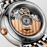 Longines Elegant Automatic caseback view showing the see-through exhibition case back, revealing the self-winding mechanical movement within. The stainless steel and rose gold case finishing is visible around the edge, reflecting the watch's premium construction.