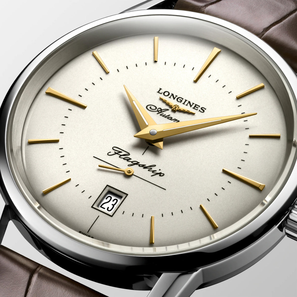 Close-up of the silver dial on the Longines Heritage Flagship Automatic Men’s 38.5mm Watch L4.795.4.78.2, showing the stick and dot hour markers, dauphine hands, small seconds sub-dial and date window. The dial sits beneath scratch-resistant sapphire crystal.