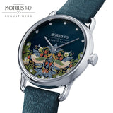 Morris & Co x August Berg watch featuring a dark blue dial with a detailed botanical and bird illustration, a silver-toned case, and a textured teal leather strap.