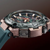 Side profile of the Casio G-SHOCK MRG-B2000KT-3A Limited Edition Men's Solar Watch, 49mm case, showing the titanium case depth and sapphire-coated screws. The blue-green Dura Soft rubber band is visible along the watch's profile.