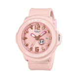 Casio Baby-G+PLUS BGA15K-4A front view, featuring the round pastel pink matte resin case with shimmering metal dial, Arabic numerals at 12 and 6 o'clock, rotating seven-design day display, three analogue hands, and matching pastel pink matte band — shown as a wristwatch with detachable silicone holder included.