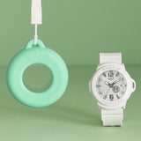 Casio Baby-G BGA15K-7A front view showcasing the clean white matte bezel and band with shimmering dial and green accent details, pop-inspired rotating day display, and three-hand analogue face — a fresh, bright take on the Baby-G+PLUS convertible series with matching green silicone holder.