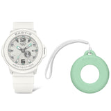 Casio Baby-G+PLUS BGA15K-7A front view — white matte round resin case and band, shimmering metal dial with green accents, Arabic numerals, three-hand analogue display with rotating day design. Includes green silicone bag charm holder. 43.5mm x 42.4mm, 35 grams, shock resistant, 100M water resistant.