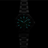 Close-up of Oris Aquis Calibre 400 green dial showing luminous hour markers in dark lightning 