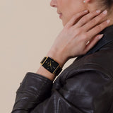 Rado Integral Diamonds 31.5mm R20256712 worn on wrist – black dial with diamond markers, square gold-tone case, gold and black ceramic bracelet, 31.5mm quartz dress watch shown on wrist