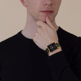 Rado Integral Diamonds 31.5mm R20256712 worn on wrist – black dial with diamond markers, square gold-tone case, gold and black ceramic bracelet, 31.5mm quartz dress watch shown on wrist