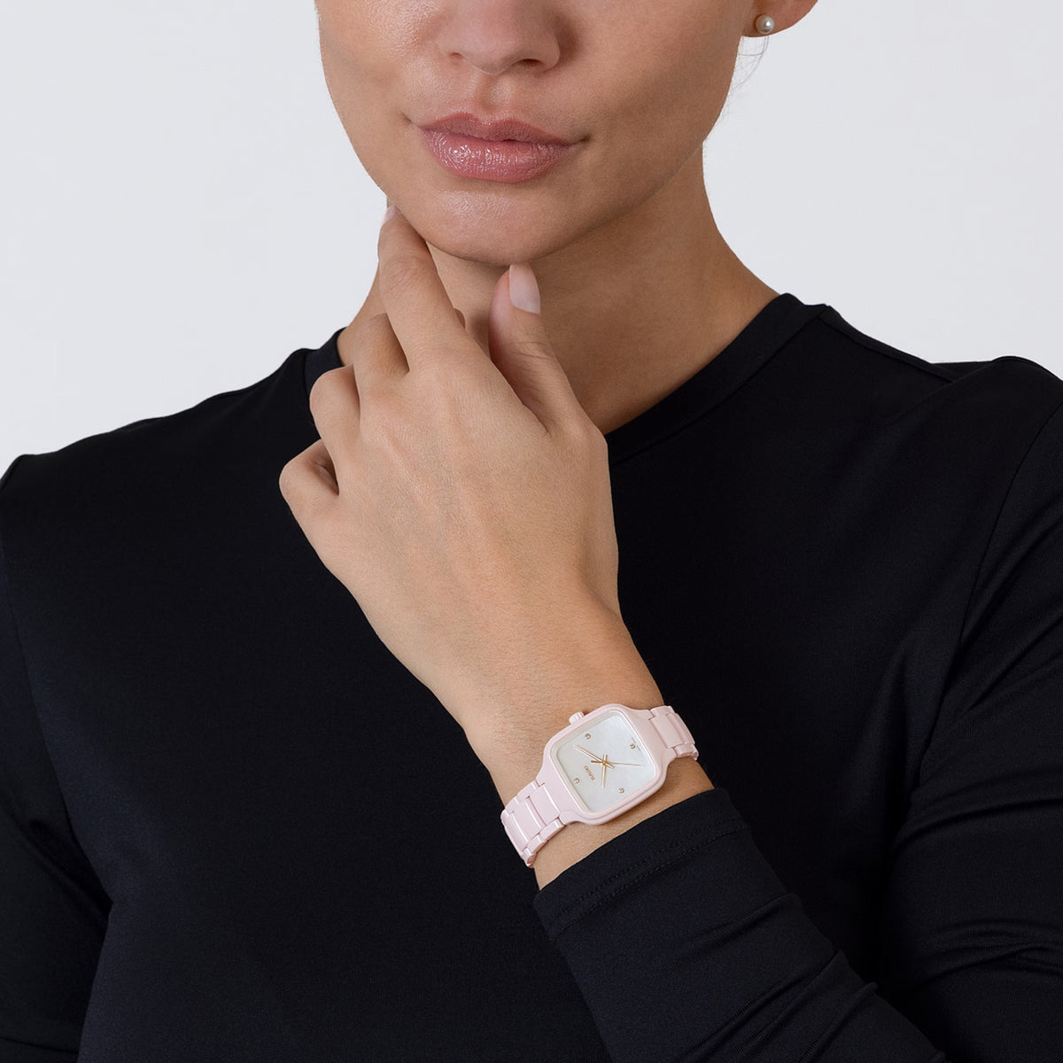 Rado True Square Diamonds 29.2mm R27181902 worn on wrist – white mother of pearl dial with diamond markers, pink high-tech ceramic case and bracelet, petite women’s square quartz watch shown on wrist