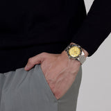 Rado Captain Cook 39mm R32223258 worn on wrist – shimmering gold dial with white Super-LumiNova® hands and indices, black ceramic bezel, stainless steel case and bracelet